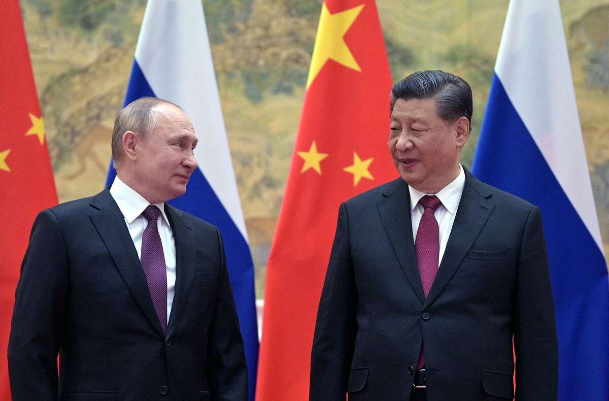 Russian President Vladimir Putin, left, and Chinese President Xi Jinping pose during their meeting in Beijing, on Feb. 4.