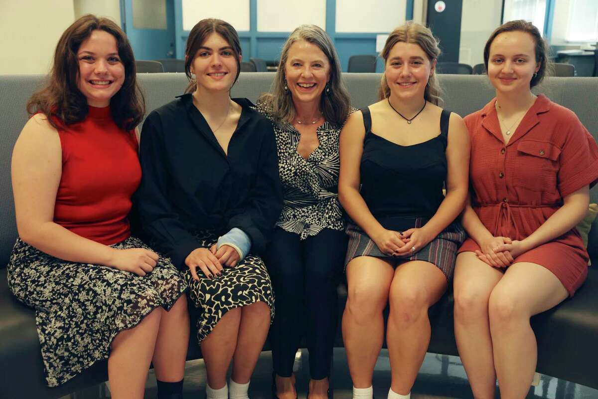 Mentor Bonnie Giddens, 57, center, with FYDER founders from left, Timandra Rowen, 18, Jamie Mayes, 18, Ava Gutierrez, 18, and Liv Humphries, 18, at Alamo Heights High School Business Incubator, Tuesday, May 10, 2022. The high school seniors started the company that recycles #5 plastics into filament used for 3D printing.