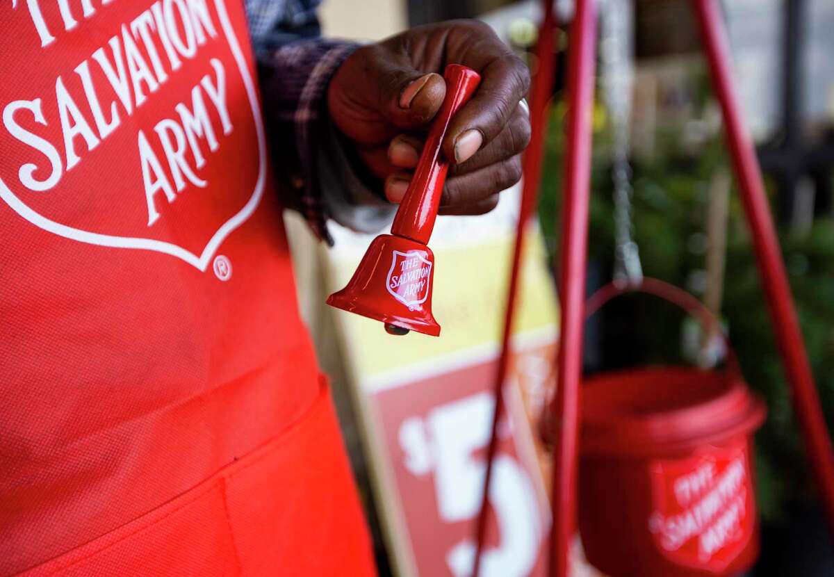 In this Nov. 23, 2020 file photo, Salvation Army bell ringer Ivory Carter Sr. rings a bell to raise funds for The Salvation Army outside the Market Street store on 42nd Street in Odessa, Texas. The Salvation Army’s latest fundraiser, by contrast, is high tech: an NFT of an album by Houston’s Billy Dorsey.