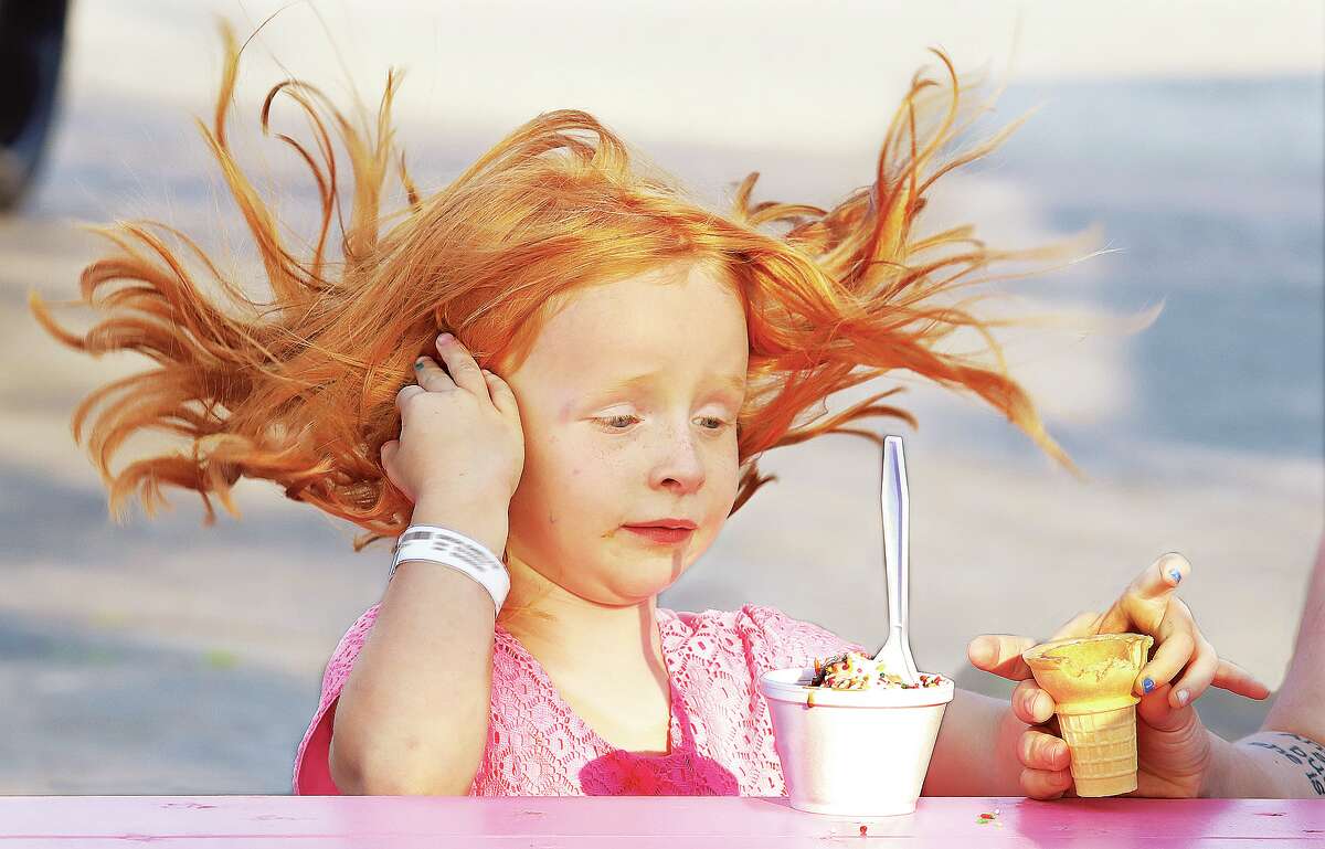 John Badman|The Telegraph It was a good week for ice cream but, as Isabella, 6, found out, it has been a bit windy. Isabella's hair was flying as she enjoyed ice cream with her family at the Pink Cow on the corner of Alby and Elm streets in Alton. The high was near 90 degrees Tuesday with heavy humidity and forecasters are calling for even hotter temperatures in the low to mid 90's for Wednesday and Thursday.