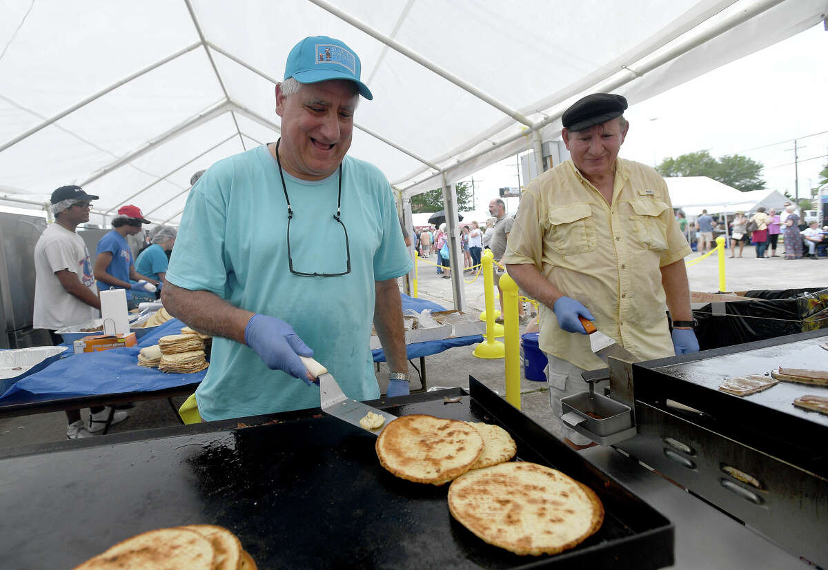 From left, John Gavrelos and Mike Stasinos keep the staples grilling at the gyro station during the annual Mediterranean Festival at St. Michael Christian Orthodox Church Saturday. Photo made Saturday, May 7, 2022. Kim Brent/The Enterprise