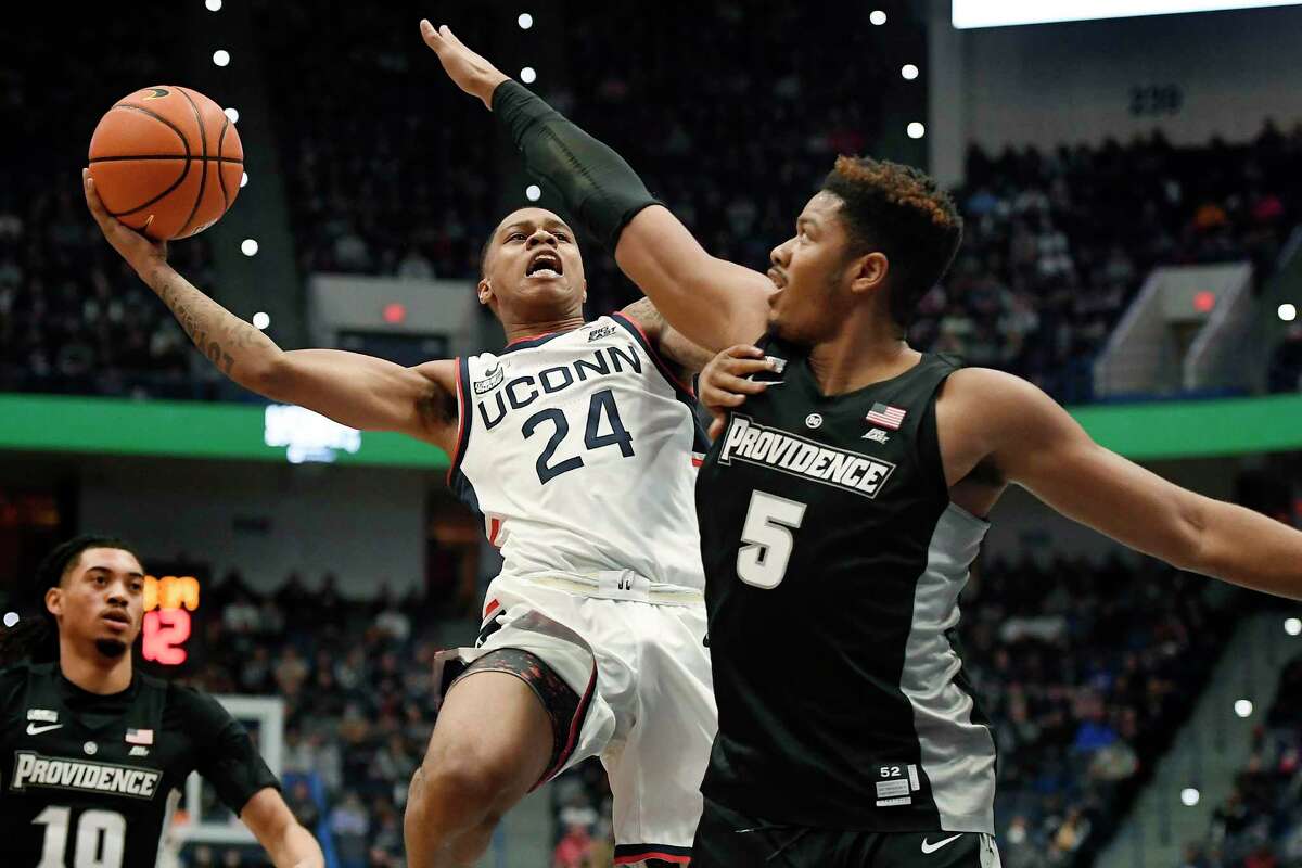 UConn’s Jordan Hawkins (24) shoots while defended by Providence’s Ed Croswell (5) on Dec. 18 at the XL Center in Hartford.