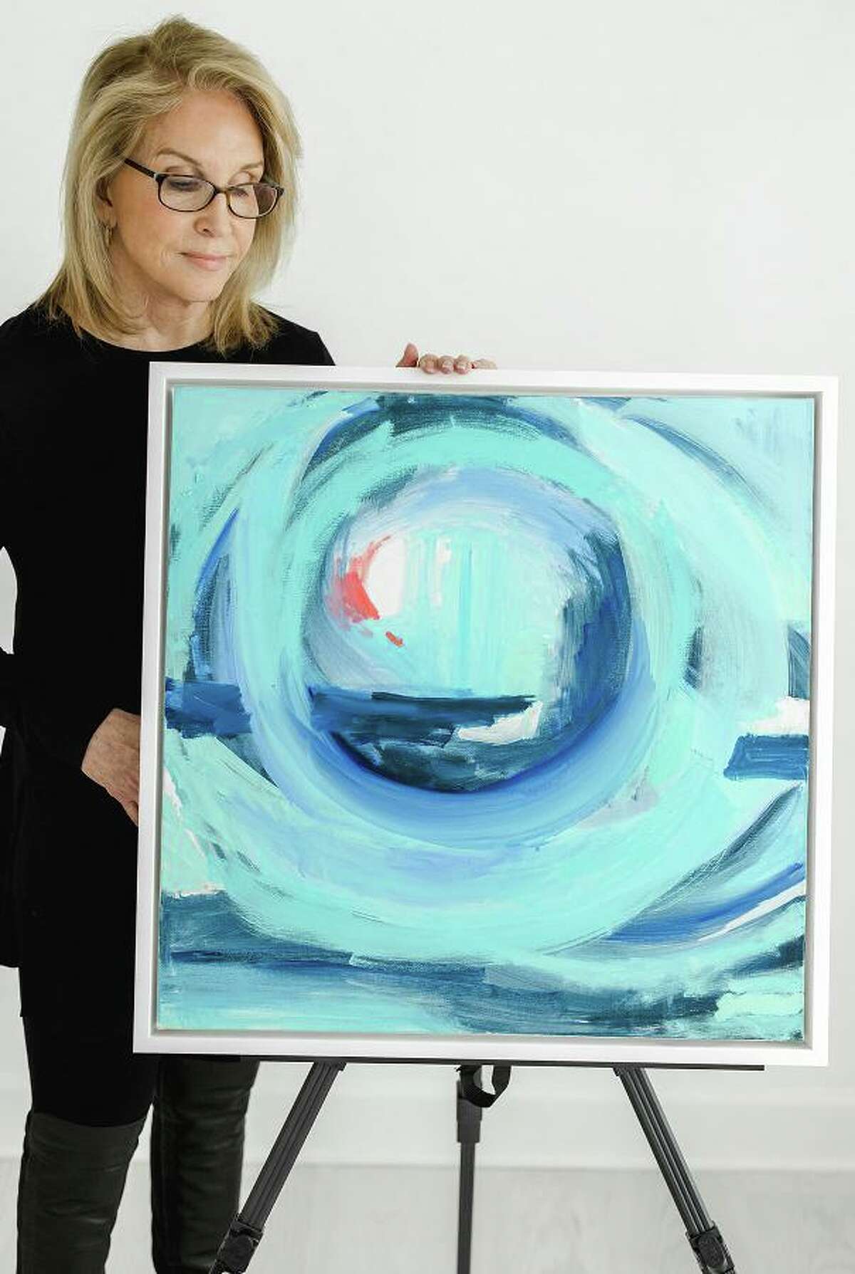 Darien artist Dana Goodfellow, shown with a piece of her artwork, will hold a solo show at the Berkshire Hathaway HomeServices in downtown Rowayton.
