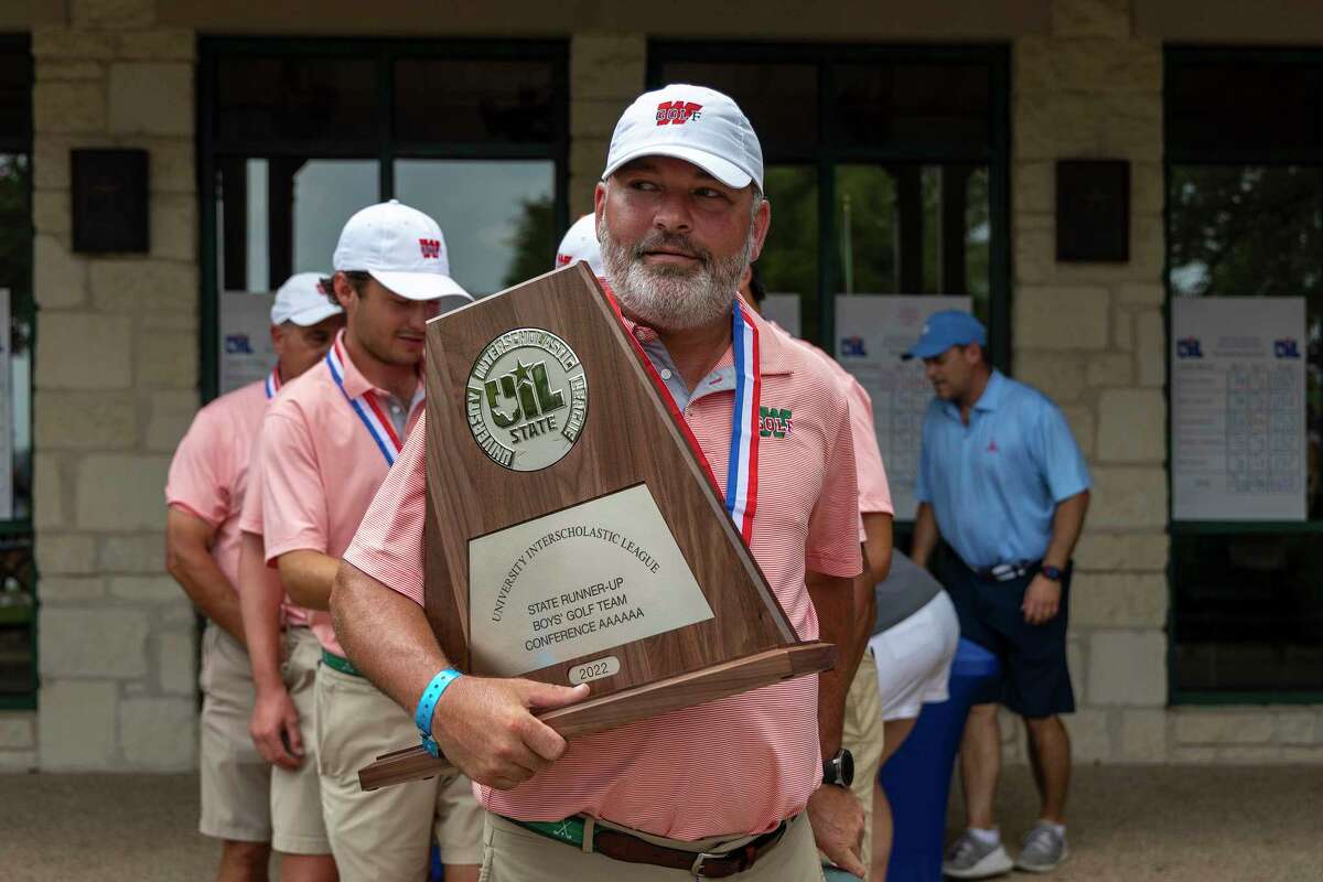 The Woodlands head coach Eric Noski carries the second place trophy during the Class 6A boys state golf tournament in Georgetown, Wednesday, May., 10, 2022.