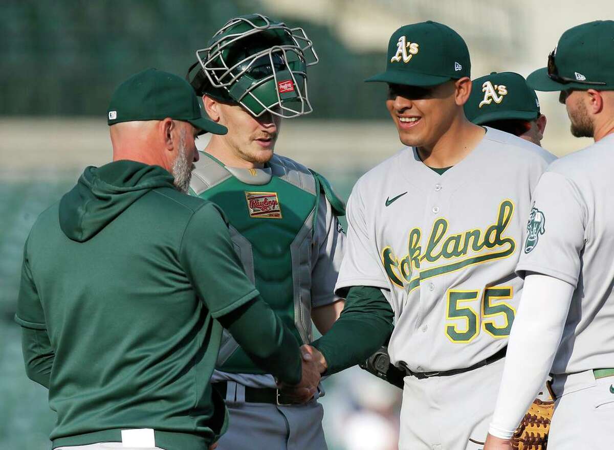 DETROIT, MI - MAY 10: Adrian Martinez #55 of the Oakland Athletics shakes the hand of manager Mark Kotsay #7 as he is pulled during the sixth inning of Game Two of a doubleheader against the Detroit Tigers at Comerica Park on May 10, 2022, in Detroit, Michigan. (Photo by Duane Burleson/Getty Images)