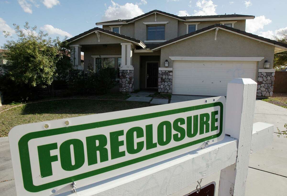 In this file photo, a foreclosure sign sits outside a home for sale. Montgomery County commissioners agreed Tuesday to remove the county’s designation for foreclosure sales to default the new location to the courthouse steps.