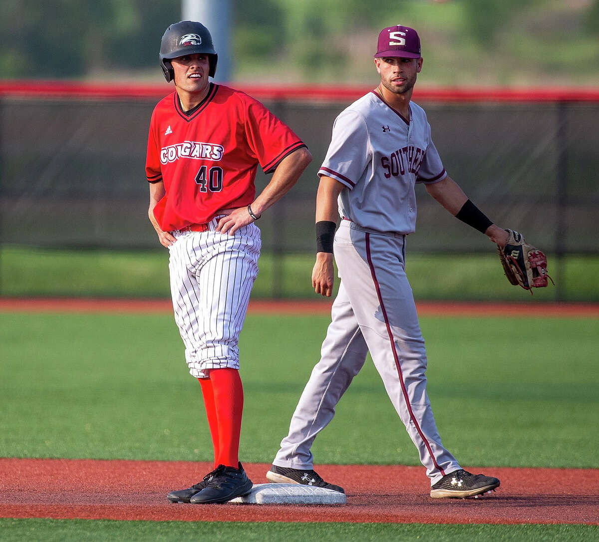 SIU Carbondale second baseman Grey Epps, right, keeps an eye on SIUE's Nic Roes during Tuesday's game in Edwardsville.