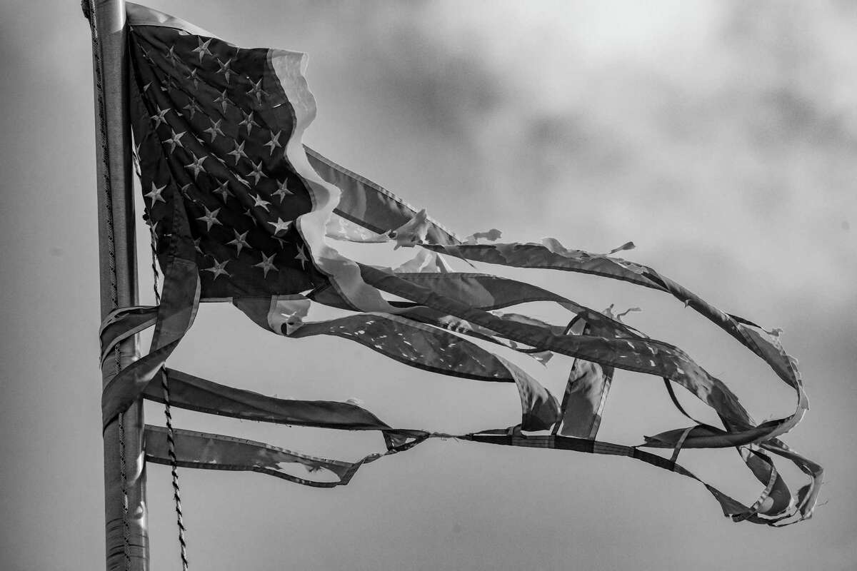 FILE ?‘ A ripped American flag in Miami, Feb. 16, 2022. ?’This is a season ?‘ an age, really ?‘ of American pessimism,?“ writes New York Times columnist Bret Stephens. (Damon Winter/The New York Times)