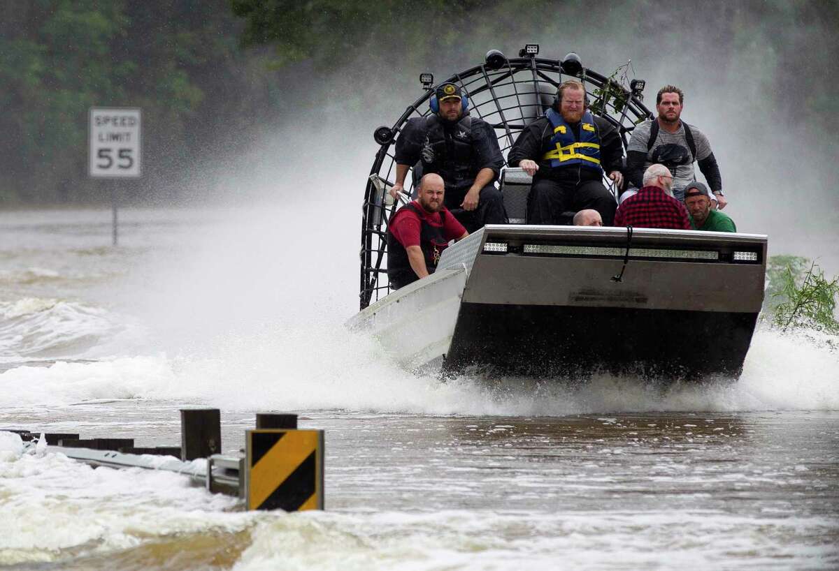 Residents are evacuated from their homes by airboat across the San Jacinto River on FM 1485, Tuesday, Aug. 29, 2017, in New Caney. Montgomery County commissioners approved the applications for several grants that would help fund projects to mitigate flooding in the county.