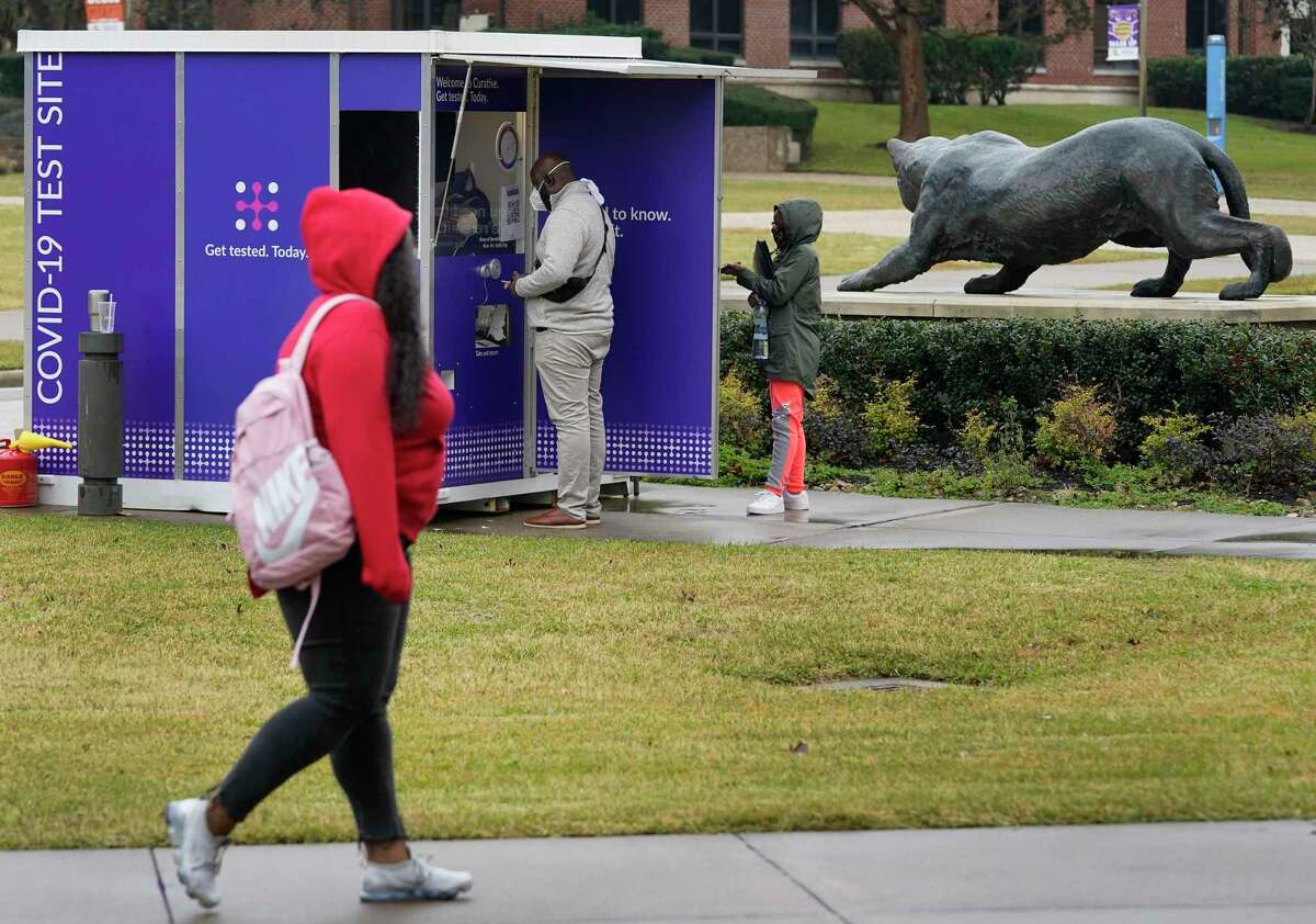 People are shown at the COVID-19 testing site at the Curative kiosk outside of the Memorial Student Center on the campus of Prairie View A&M University Monday, Jan. 24, 2022 in Prairie View, Texas.