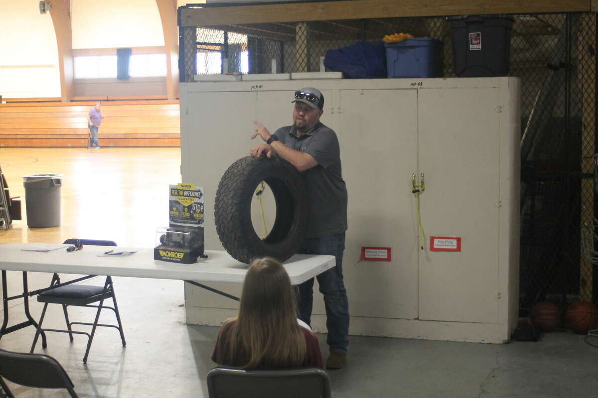 Tyler Reed, owner of Parkdale Auto Sales & Service, tells students the importance of vehicle maintenance  Tuesday during a class at the Armory Youth Project.