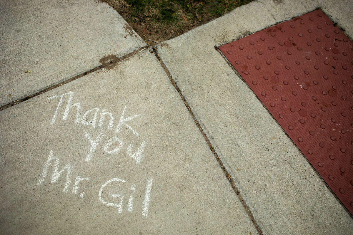 Messages of love for Gilbert Rosin, known as "Mr. Gil" to many local children at Adams Elementary, are written on the sidewalk at the intersection where he served as crossing guard. Rosin died Saturday, May 7, 2022 in his Midland home.