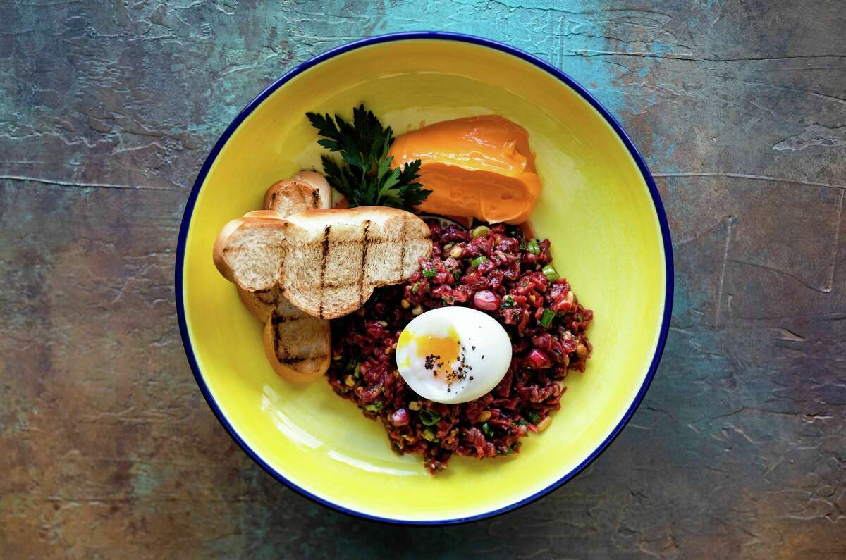 Beef tartare is served with an egg and pita at Hamsa.