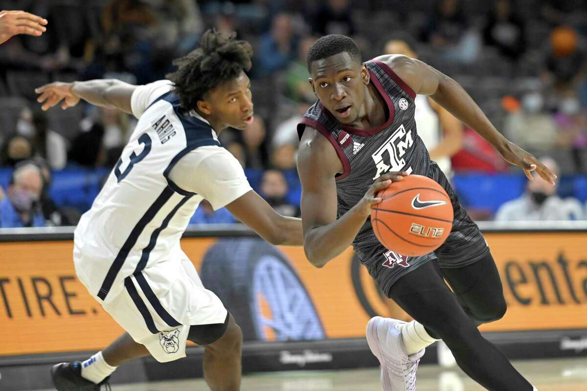 Hassan Diarra #5 of the Texas A&M Aggies drives the ball around Chuck Harris #3 of the Butler Bulldogs during the 2021 Maui Invitational basketball tournament at Michelob ULTRA Arena on November 23, 2021 in Las Vegas, Nevada.