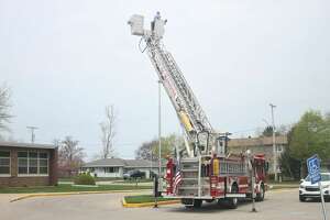 Manistee Fire Department hangs cable for Armory flag pole
