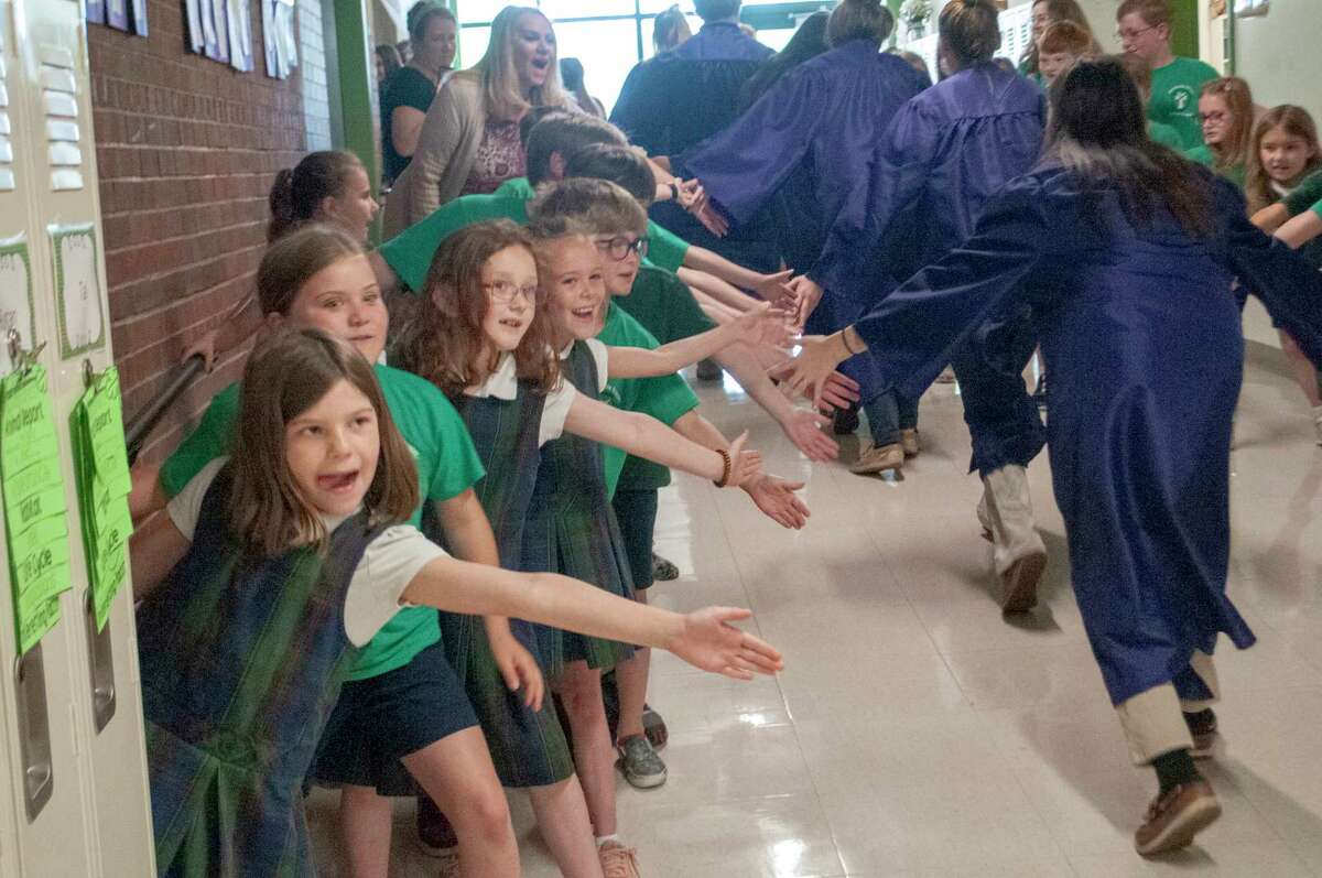 Routt Catholic High School seniors and Our Saviour School eighth-graders were celebrated as graduation approaches. After a service Wednesday, Routt seniors had a private farewell parade through the halls of Our Saviour School with students and teachers cheering them on. More photos are at myjournalcourier.com.