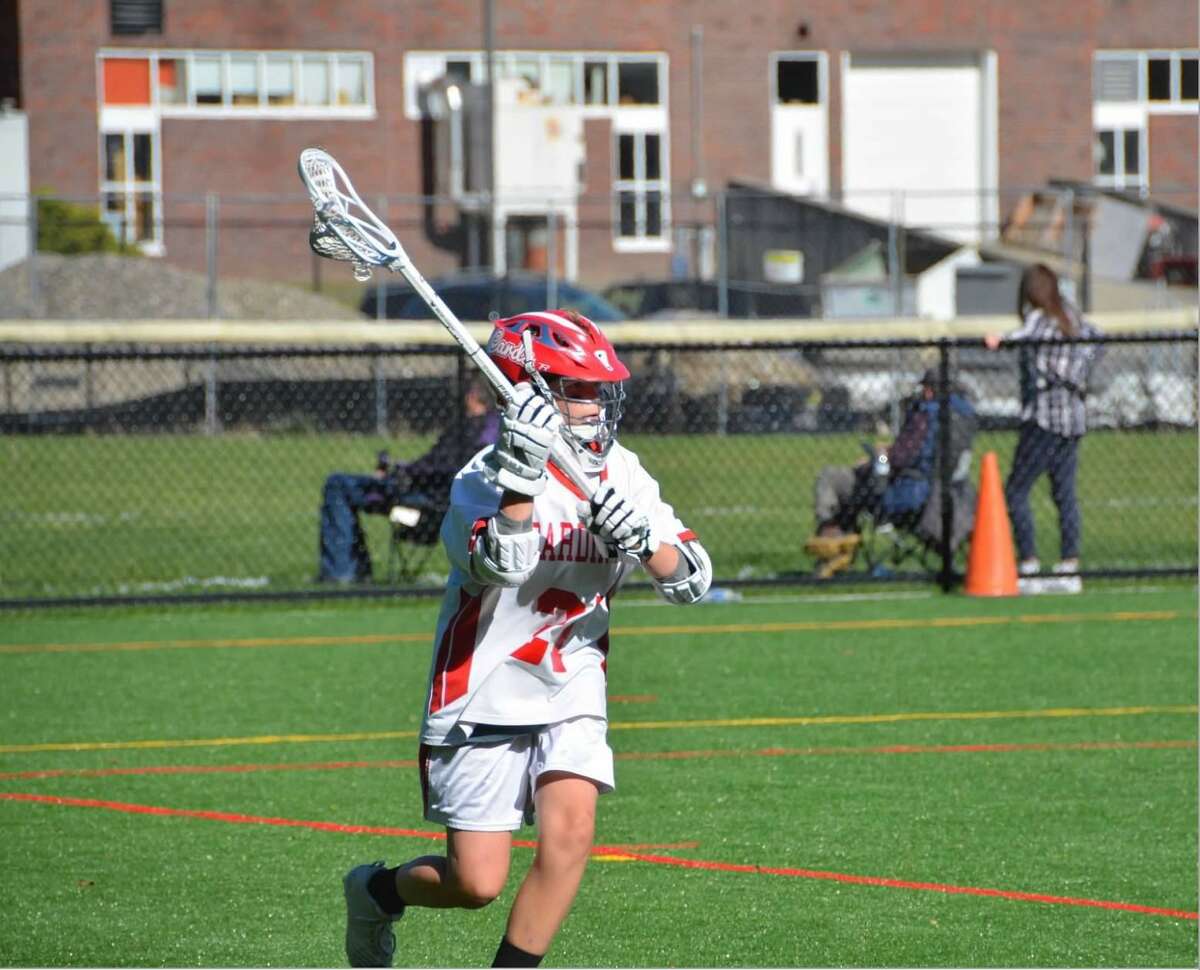 Brady Lisjak of Greenwich playing lacrosse after his right leg was lengthened 2.5 inches.