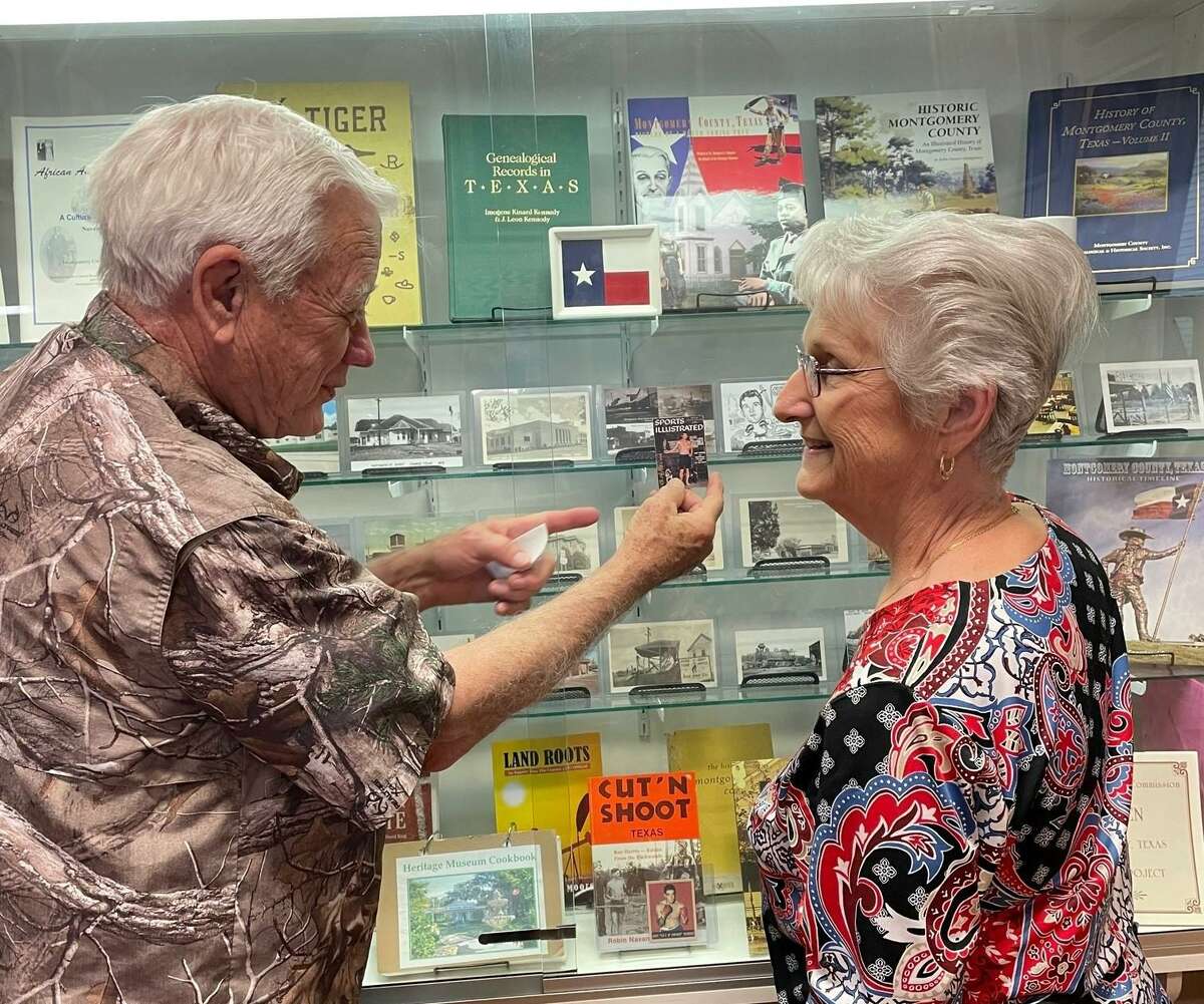 The Heritage Museum of Montgomery County recently debuted an exhibit of postcards featuring bygone Conroe landmarks. The display will be up through the end of summer. Pictured from left, James Ray shows his Roy Harris collectors card to Sue Hereford in front of the display.