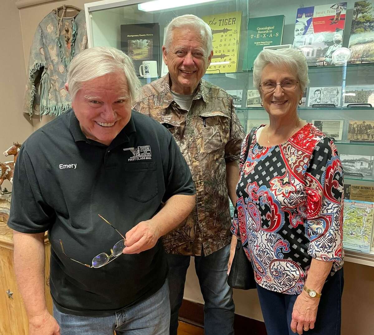 The Heritage Museum of Montgomery County recently debuted an exhibit of postcards featuring bygone Conroe landmarks. The display will be up through the end of summer. Pictured from left are Emery Heuermann, owner of the postcards, James Ray and Sue Hereford.