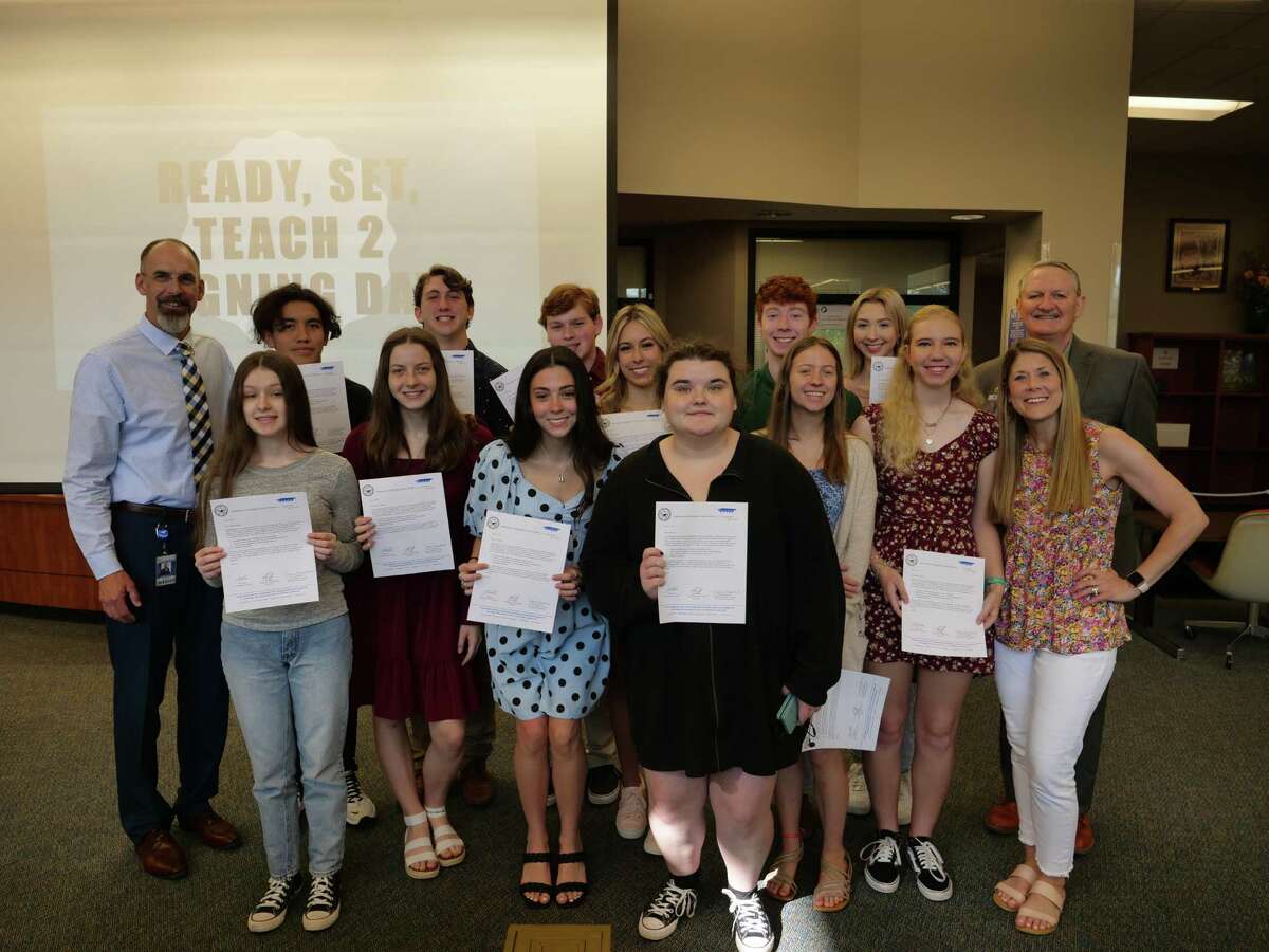Seniors in Friendswood High School’s Ready, Set, Teach program receive letters guaranteeing an employment interview for positions with Friendswood Independent School District once they obtain their teaching certificate. In front are: Hannah Maurer, left, Aymee Thompson, Ava Barber, Zoe Kirk, Melody Hall, Emily Confair and RST teacher Brooke Holtvluwer. Behind them are: Superintendent Thad Roher, left, Joel Sanchez, Alex Skinner, Jake Cipolla, Kelli Mulloy, Garrison Fritts, Elise Whittenburg and Principal Mark Griffon.
