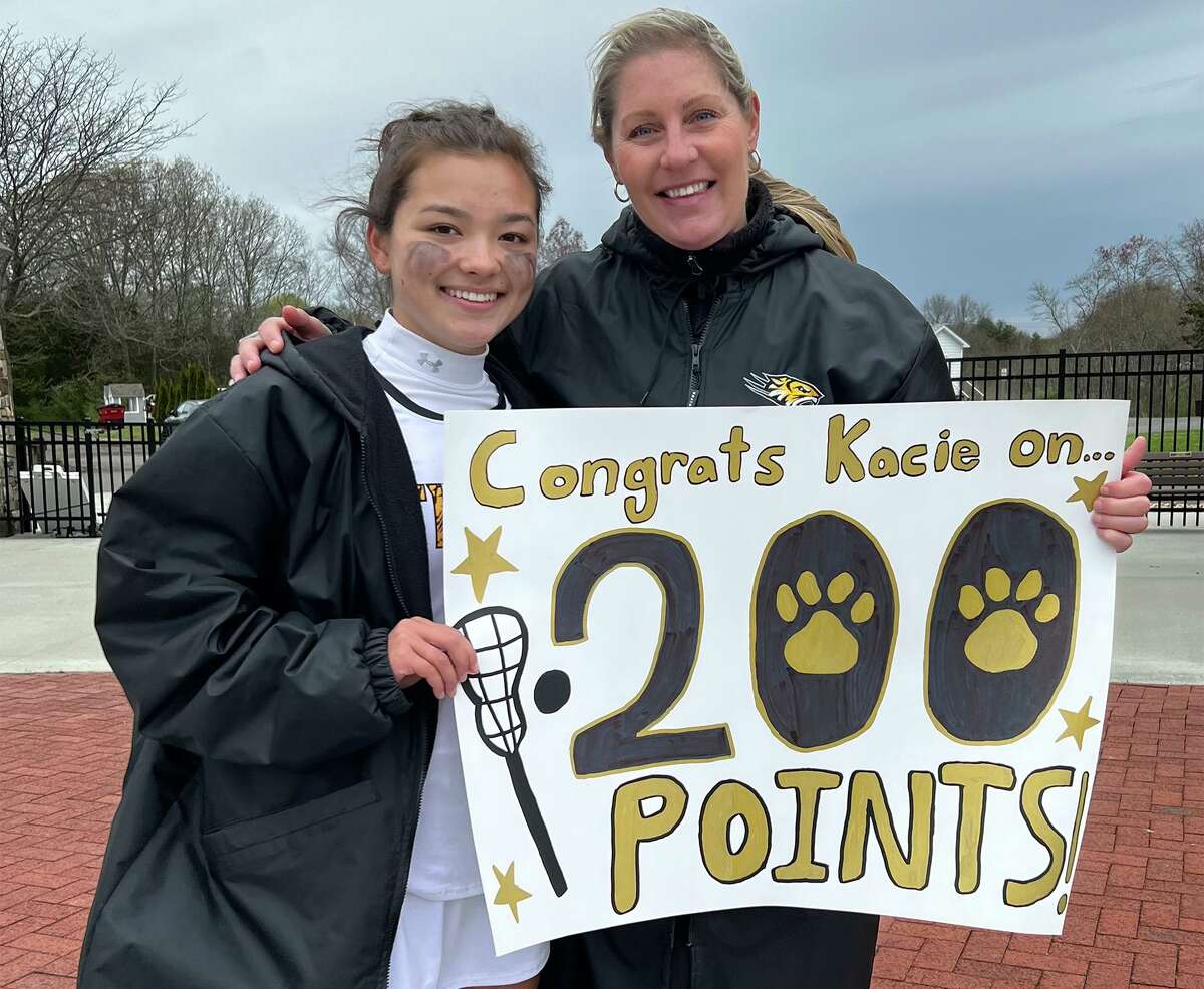 Kacie Wines of the Daniel Hand girls lacrosse team celebrate her milestone 200th point during the Tigers' win over Simsbury on Saturday, May 7, 2022.