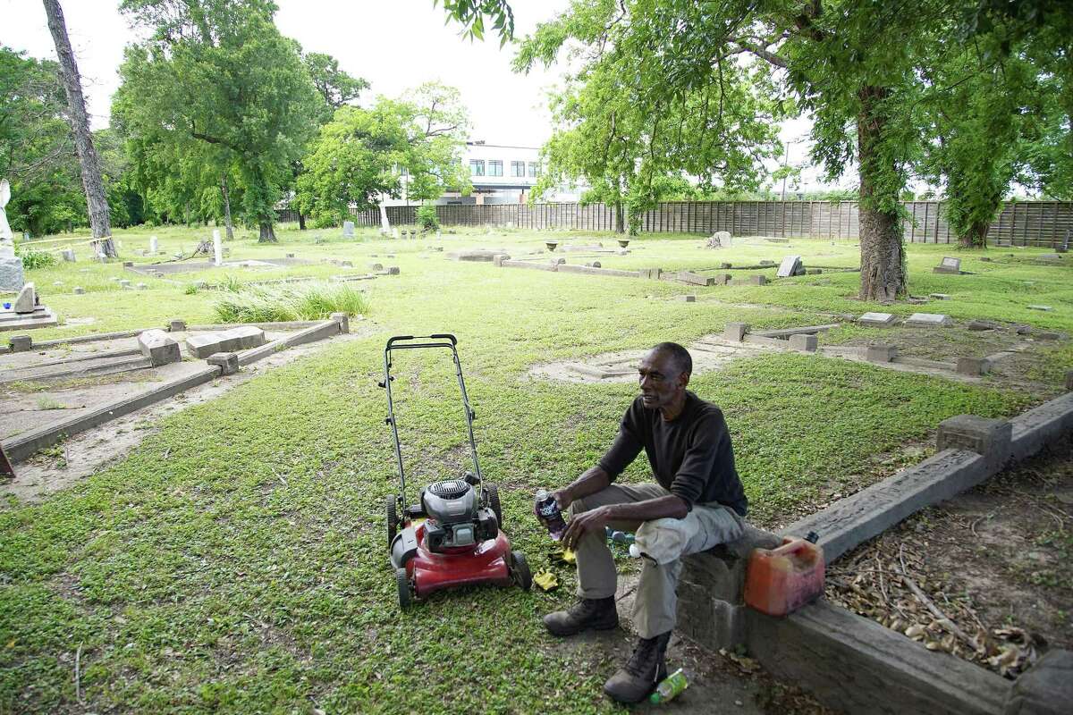 Volunteer Charles Cook takes a break as he mows the lawn at Olivewood Cemetery in Houston on Friday, May 7, 2021.