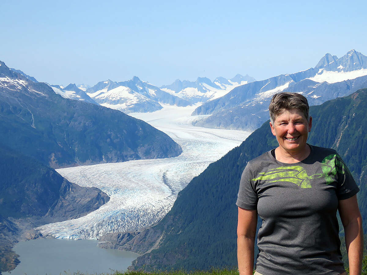 Holdener hiking Thunder Mountain in Juneau, Alaska, with the Mendenhall Glacier in the background.
