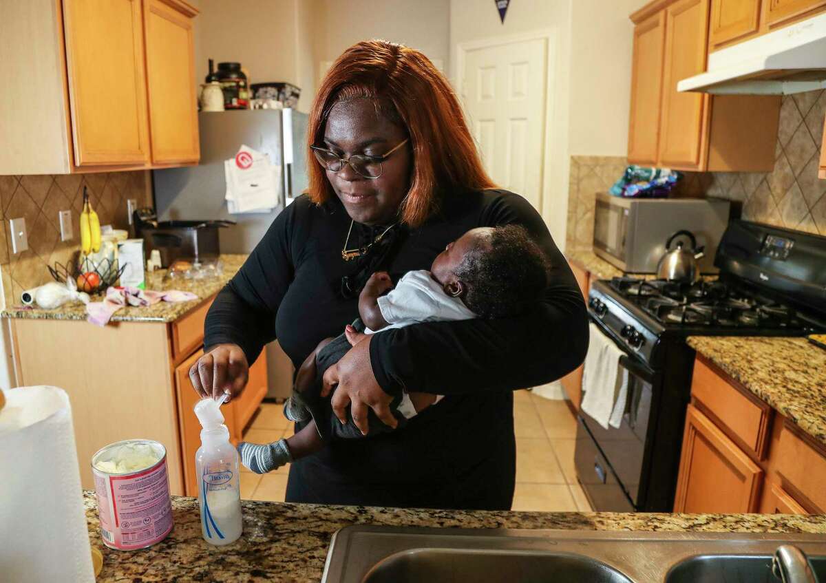 Synquise Winston, 29, mixes up a bottle of Enamel AR while holding her two-month-old son, Jaiore Carter at her home on Wednesday, May 11, 2022 in Katy. She is a mom who has been affected by the formula shortage. Her son was born in March and she's been having trouble finding formula ever since she had him. She's drive as far as College Station, Huntsville and Conroe to get formula for him.