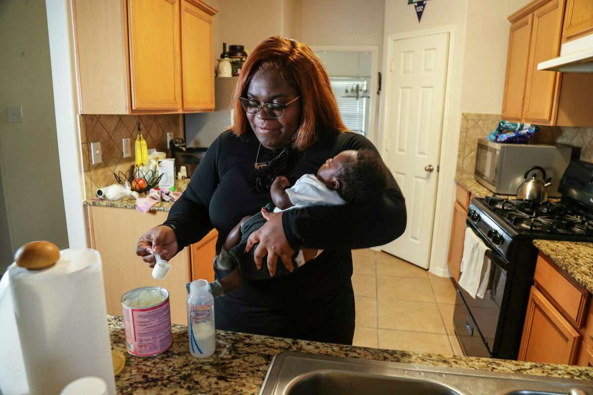 Synquise Winston, 29, mixes up a bottle of Enamel AR while holding her two-month-old son, Jaiore Carter at her home on Wednesday, May 11, 2022 in Katy. She is a mom who has been affected by the formula shortage. Her son was born in March and she's been having trouble finding formula ever since she had him. She's drive as far as College Station, Huntsville and Conroe to get formula for him.