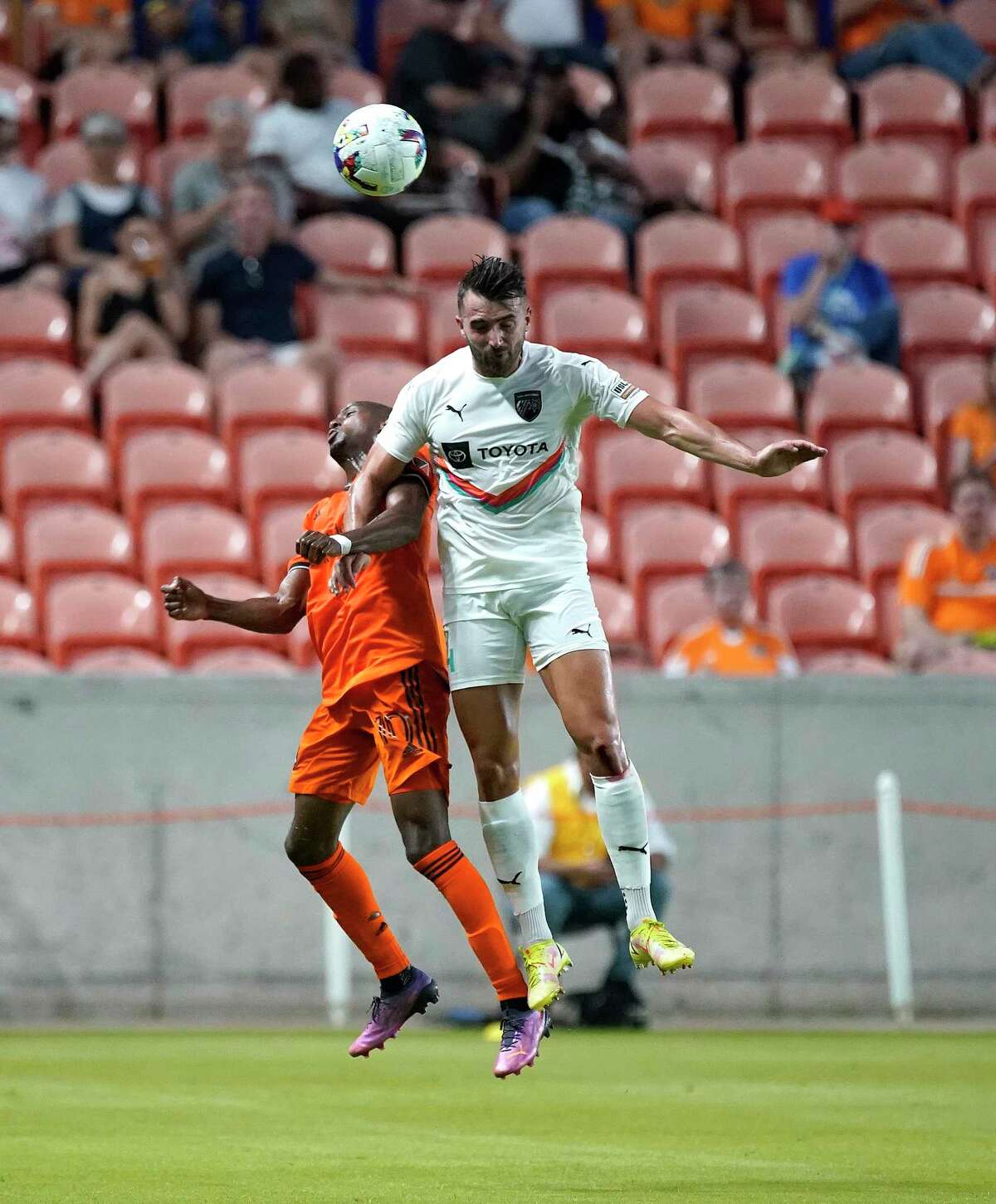 San Antonio FC defender Fabien Garcia (4) and Houston Dynamo midfielder Fafà Picault (10) go up against each other on a header during the first half of the U.S. Open Cup soccer match at PNC Stadium on Wednesday, May 11, 2022 in Houston.