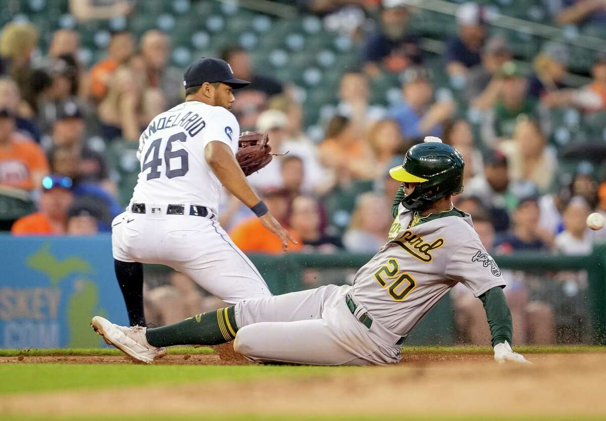 A’s center fielder Cristian Pache slides into third base after Chad Pinder’s fourth-inning single as the Tigers’ Jeimer Candelario awaits the throw. Pache was 1-for-3 in the game.