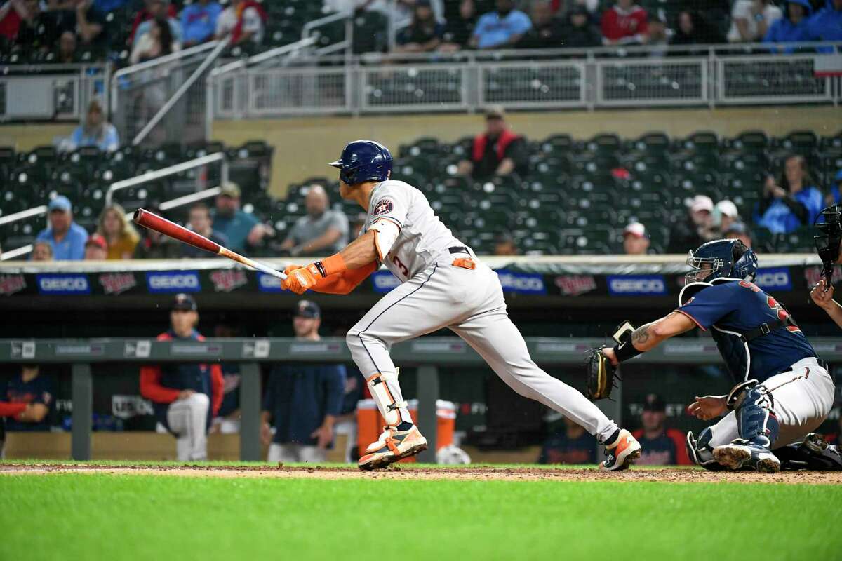 Houston Astros' Jeremy Pena (3) hits a single to right field driving in two runs as Minnesota Twins catcher Gary Sanchez looks during the third inning of a baseball game, Wednesday, May 11, 2022, in Minneapolis. (AP Photo/Craig Lassig)