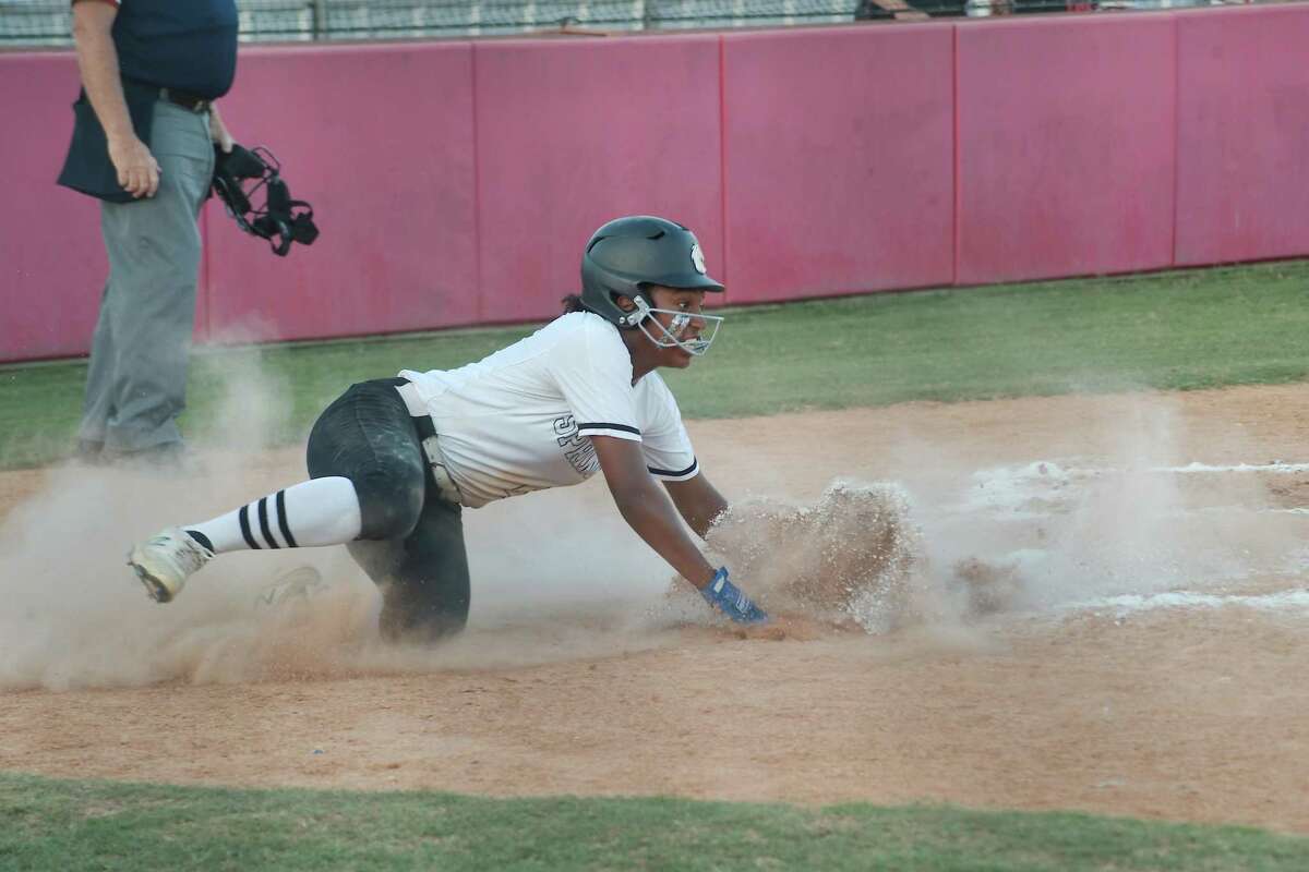 Clear Springs’ Emma King (4) slides across home plate for a run against Pearland Wednesday, May 11, 2022 at Manvel High School.