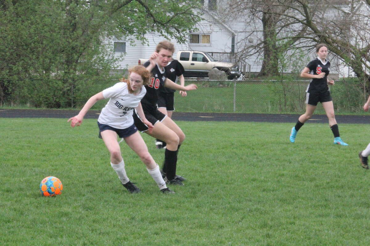 Big Rapids Teresa Vance (7) battles Reed City's Nora Smoes (10) for the ball in Wednesday soccer action.