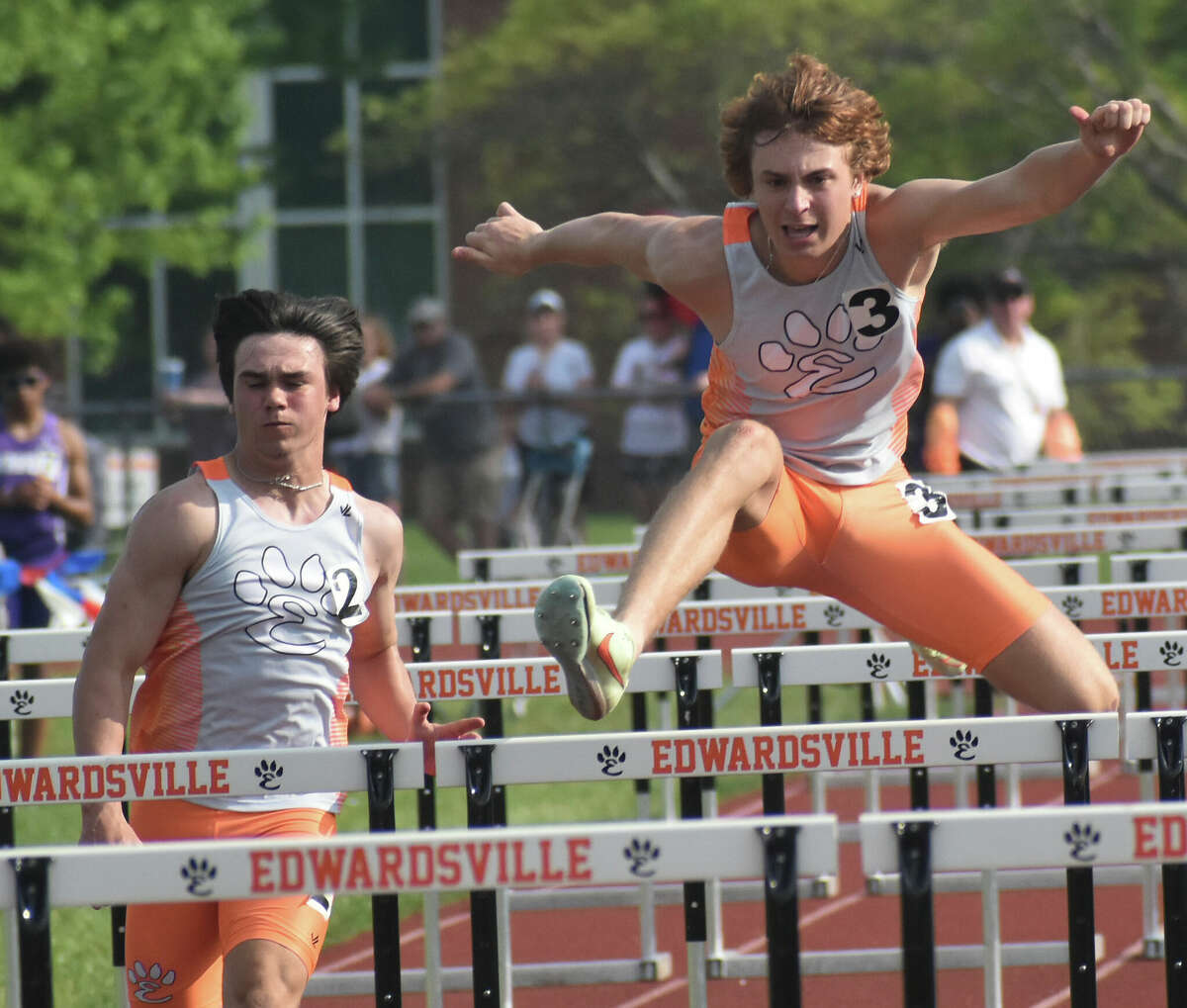 Edwardsville's Jake Curry, left, and Clayton Lakatos compete in the 110-meter hurdles during the Southwestern Conference Meet at the Winston Brown Track and Field Complex on Wednesday in Edwardsville.
