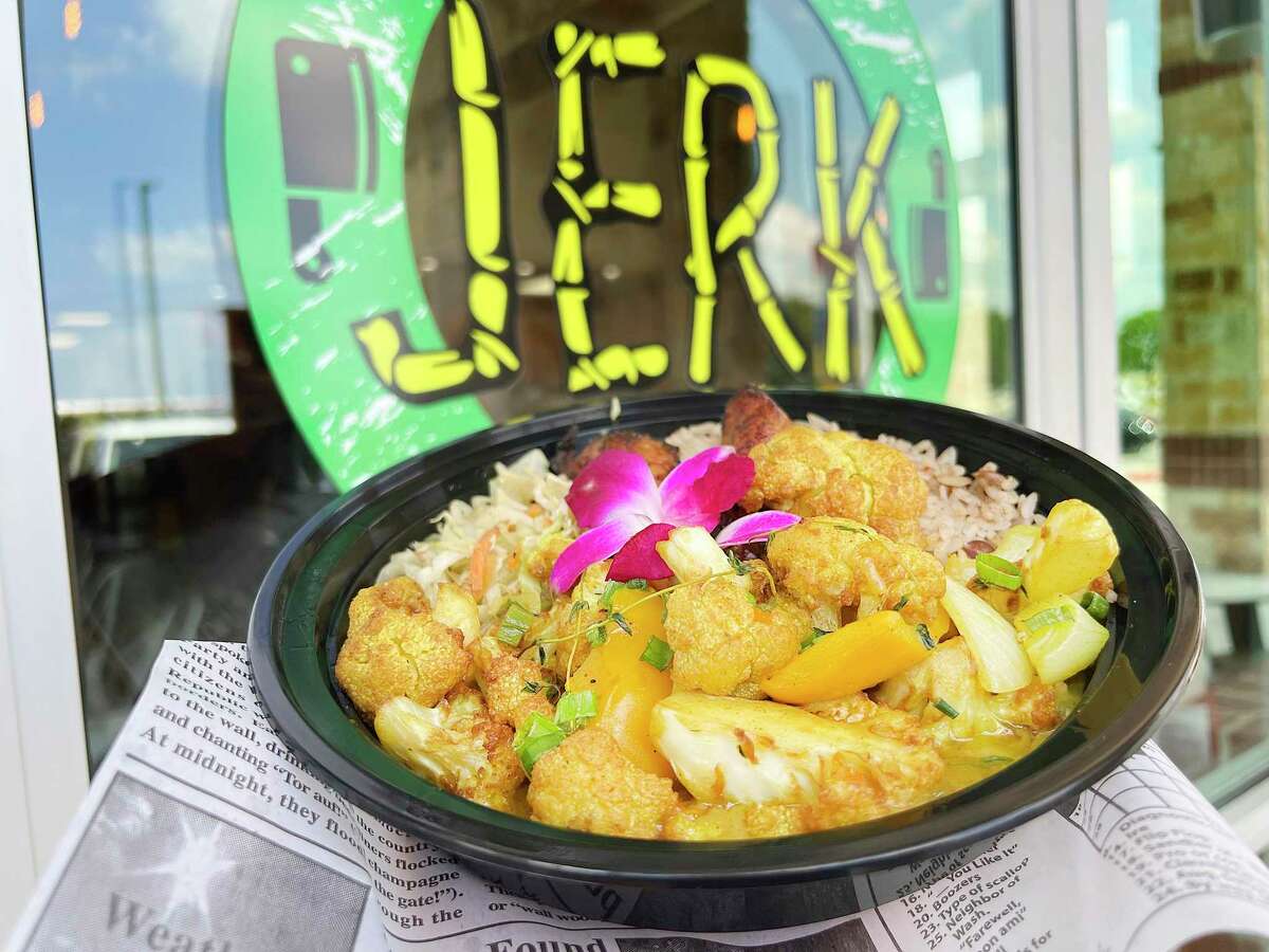 Roasted cauliflower curry comes with sauteed cabbage and rice and peas at The Jerk Shack, a Jamaican and Caribbean restaurant near SeaWorld.