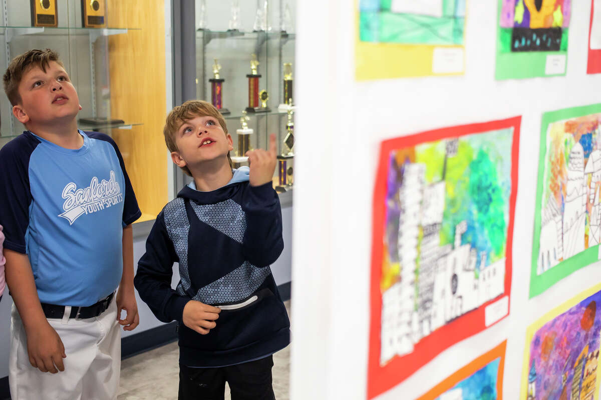 Mason Clark, 9, left, and Carson Cryderman, 9, right, admire artworks created by Meridian students during the district's annual art show Wednesday, May 11, 2022 at the Meridian High School Auditorium.