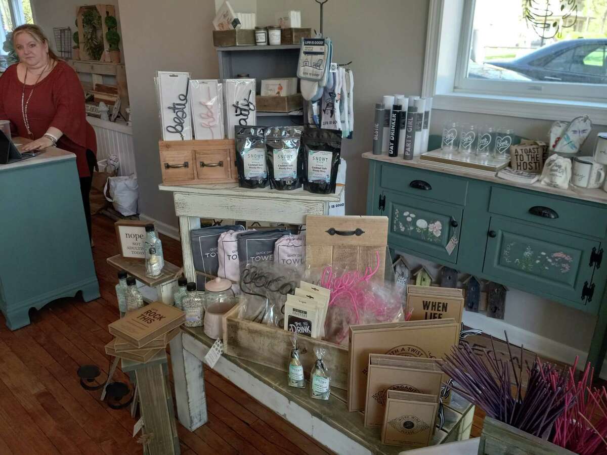 Live at Home, a home decor, gift and furnishing store, recently opened on southern Main Street in Winsted. A display of drink mixes and accessories is displayed near the front counter, where owner Jackie McNamara stands.