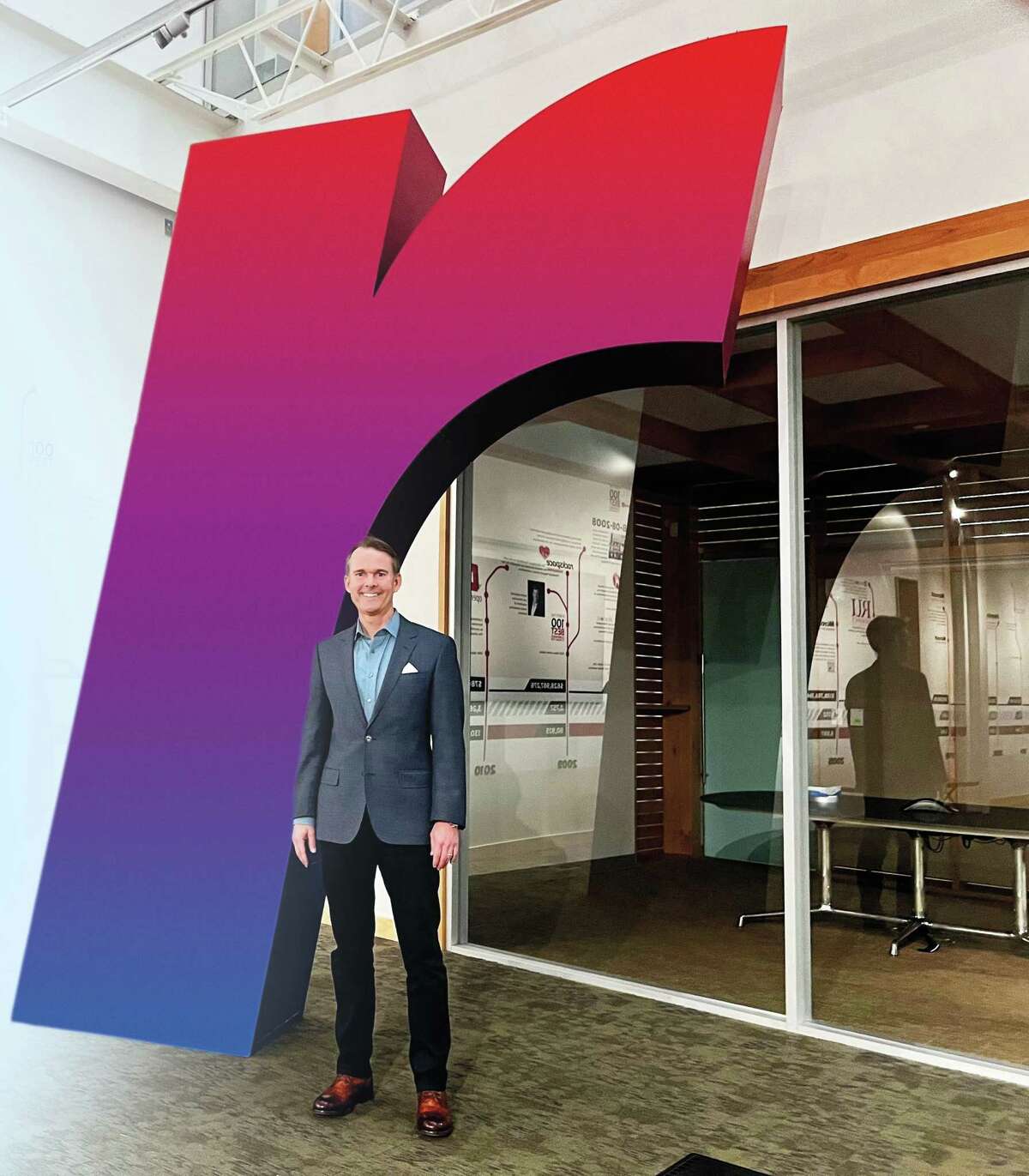 Rackspace CEO Kevin Jones with the company logo in its offices.