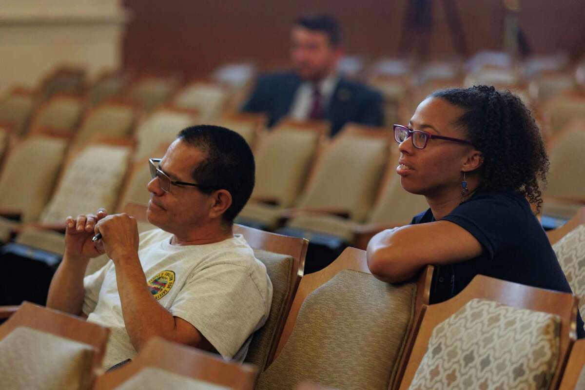 Ananda Tomas, right, executive director of ACT 4 SA, listens to public comments in the City Council Chambers.