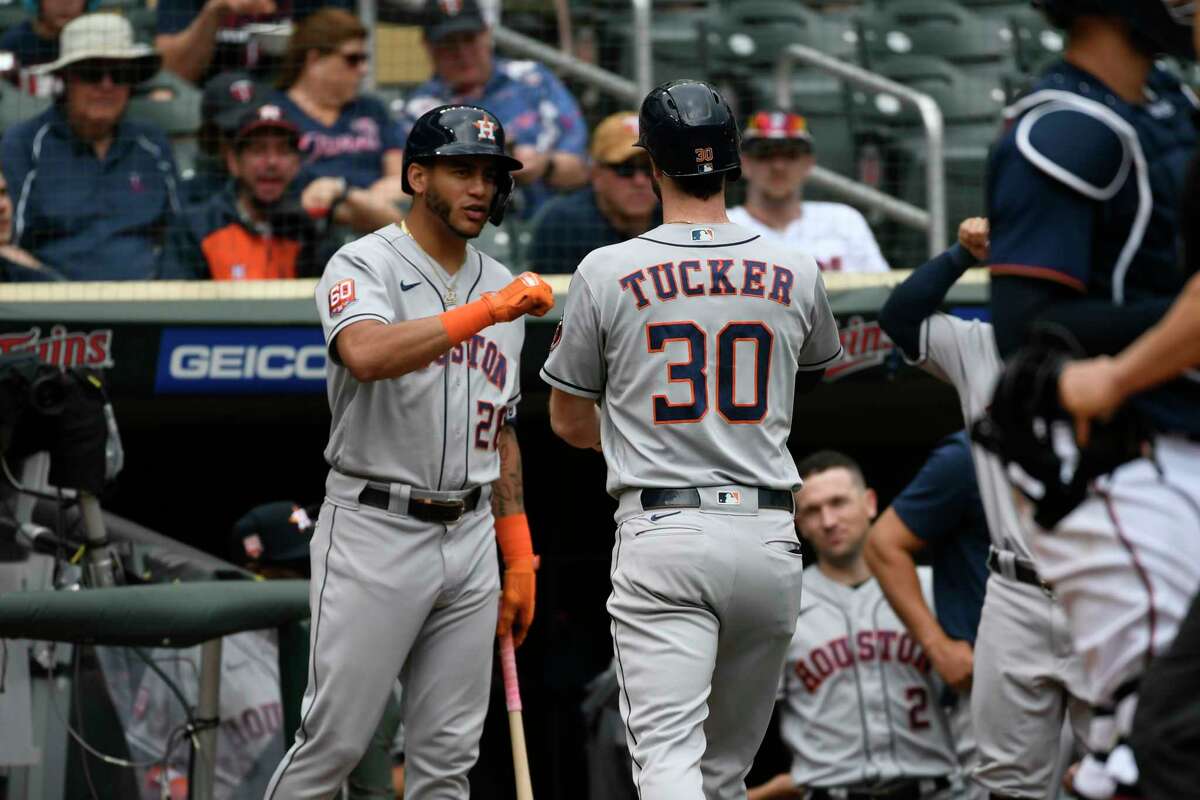 Houston Astros right fielder Kyle Tucker (30) celebrates with Jose Siri (26) after Tucker hit a solo home run against Minnesota Twins pitcher Yennier Cano during the sixth inning of a baseball game that was suspended after three innings Wednesday due to severe weather, Thursday, May 12, 2022, in Minneapolis. (AP Photo/Craig Lassig)