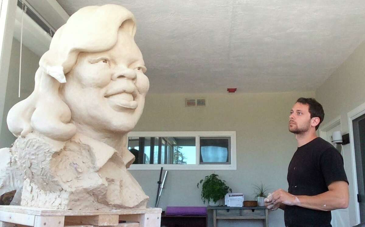 Oakland artist Leo Carson works on a new and larger sculpture of Breonna Taylor after one that he installed in Latham Square in 2020 was vandalized and then disappeared.