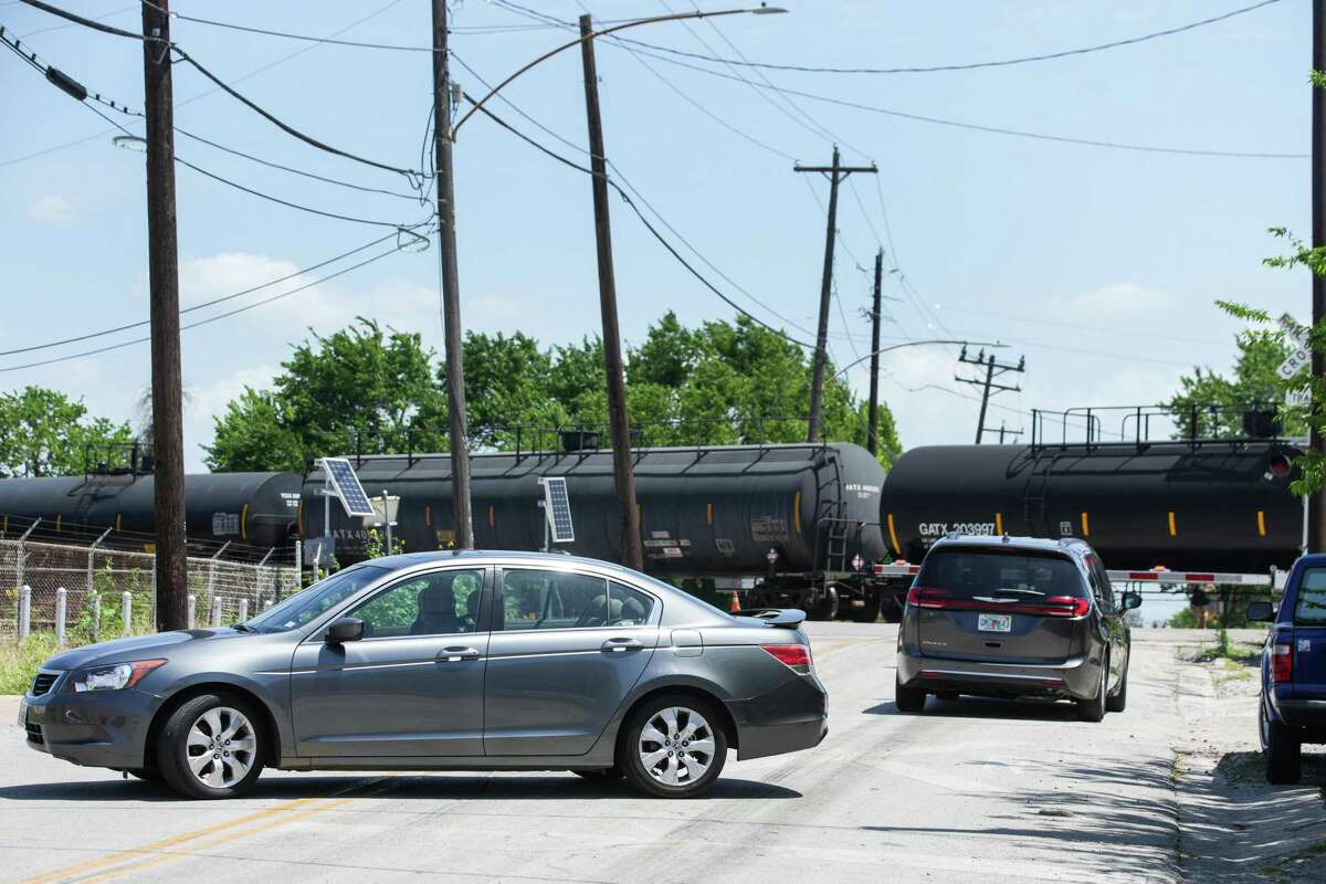 A a vehicle turns around as a stopped train blocks traffic on Milby in the East End on Tuesday, May 10, 2022 in Houston.