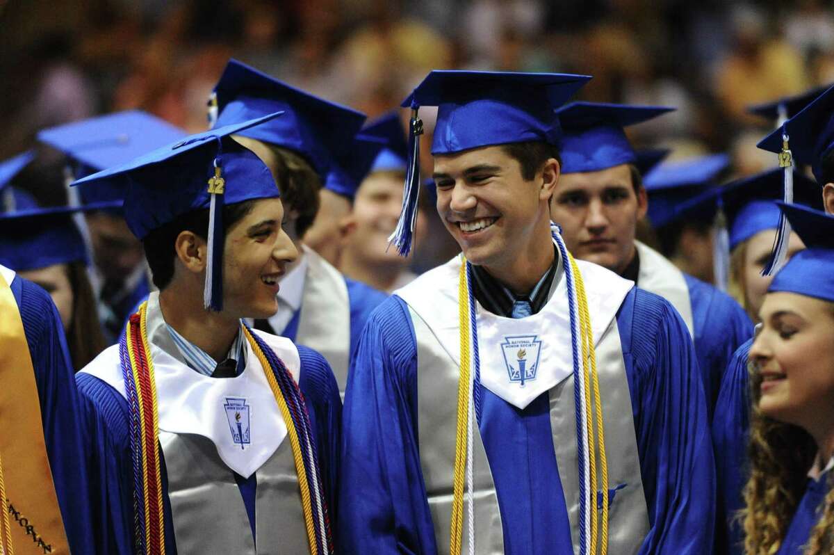 Graduates wait to walk across the stage during the Friendswood High School graduation ceremony in 2017. Clear Creek, Friendswood and Dickinson ISDs will conduct graduation ceremonies this month.