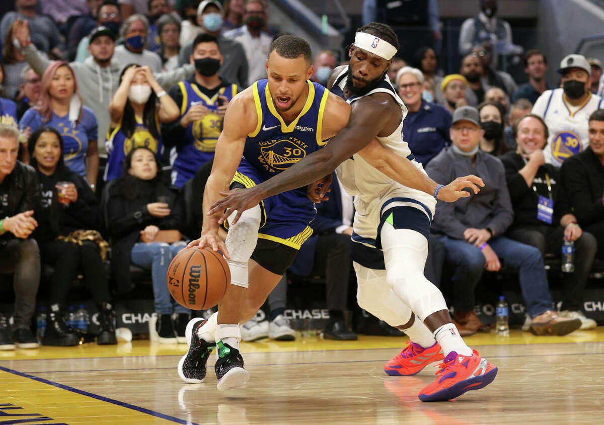 Stephen Curry of the Golden State Warriors is guarded by Patrick Beverley of the Minnesota Timberwolves at Chase Center on Nov. 10, 2021.