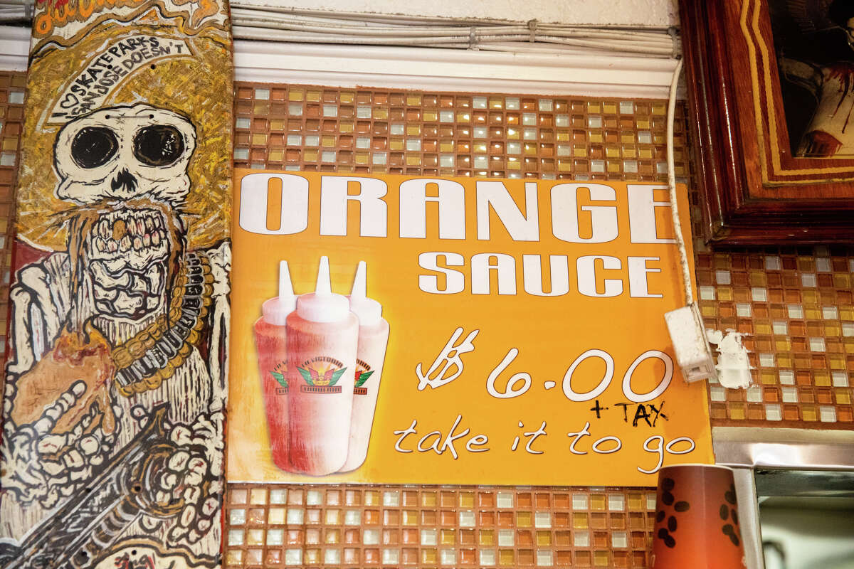 A sign informs customers they can buy La Victoria Taqueria orange sauce at its restaurant in San Jose, Calif., on May 10, 2022.
