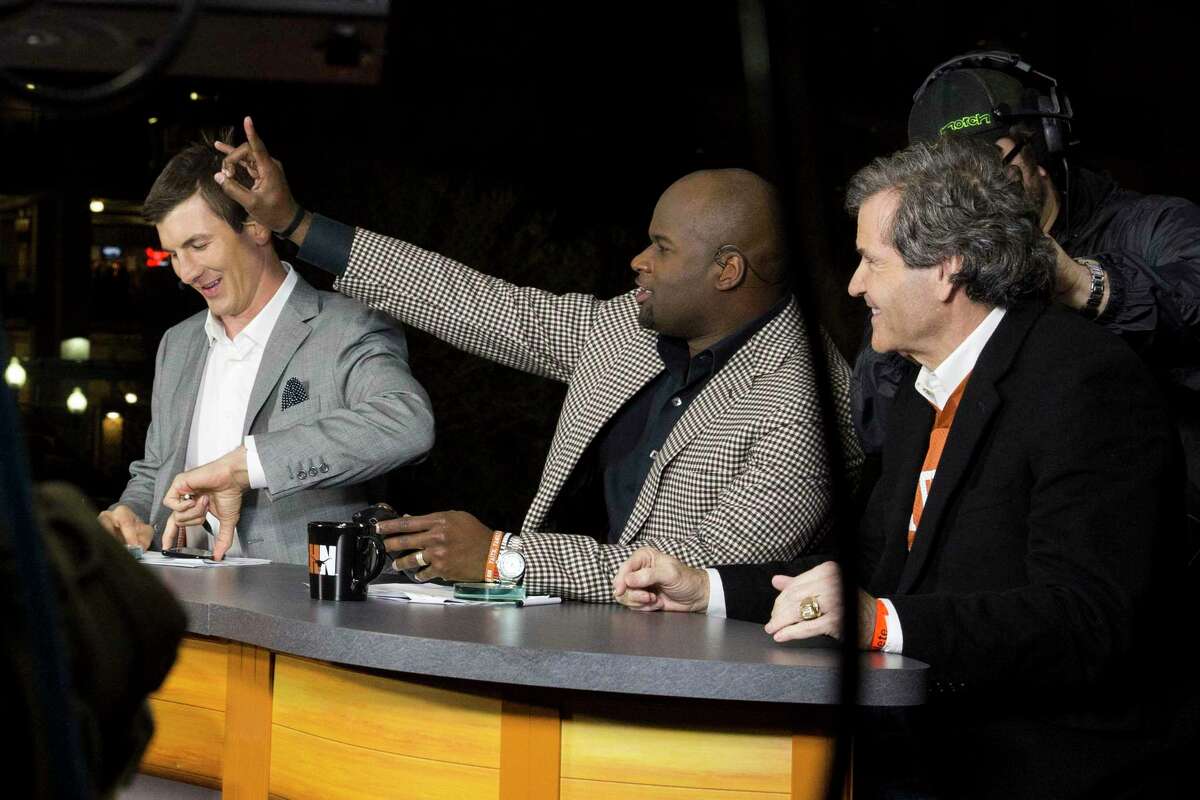 Former Texas quarterback Vince Young flashes the Hook ’Em Horns sign at fans before broadcasting a game for the Longhorn Network.