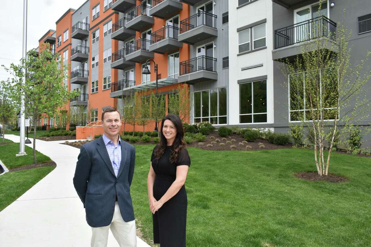 Ted Ferrarone, co-president of Building & Land Technology, and BLT area manager Rebecca Marlowe on Wednesday, May 11, 2022, outside the newest Curb apartment building on Glover Avenue in Norwalk, Conn.