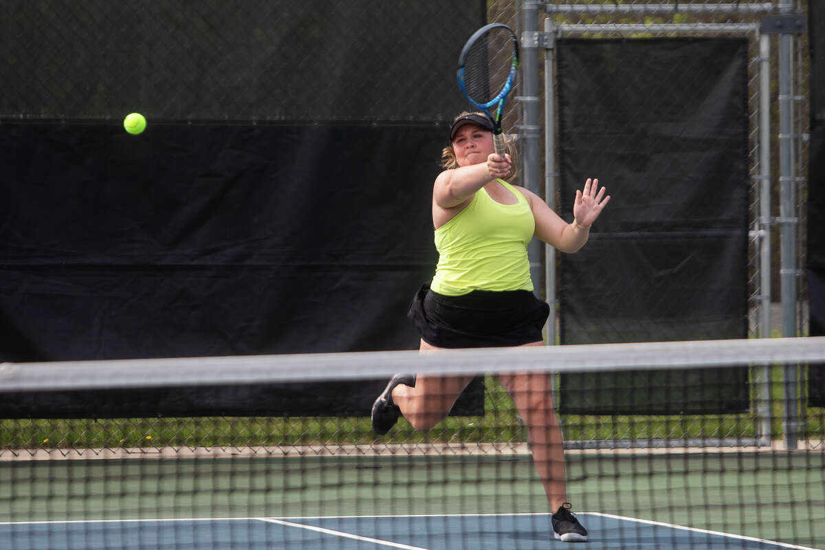Dow's #3 singles player Claire Earley competes in the Saginaw Valley League tournament Thursday, May 12, 2022 at the Greater Midland Tennis Center.