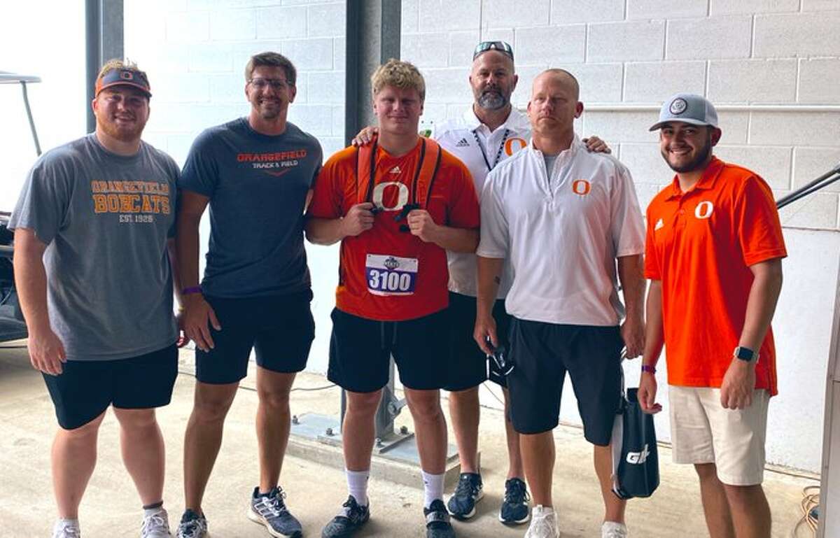 Hunter Ashworth and his coaches pose after competing in the 4A state shot put event on Thursday in Austin.